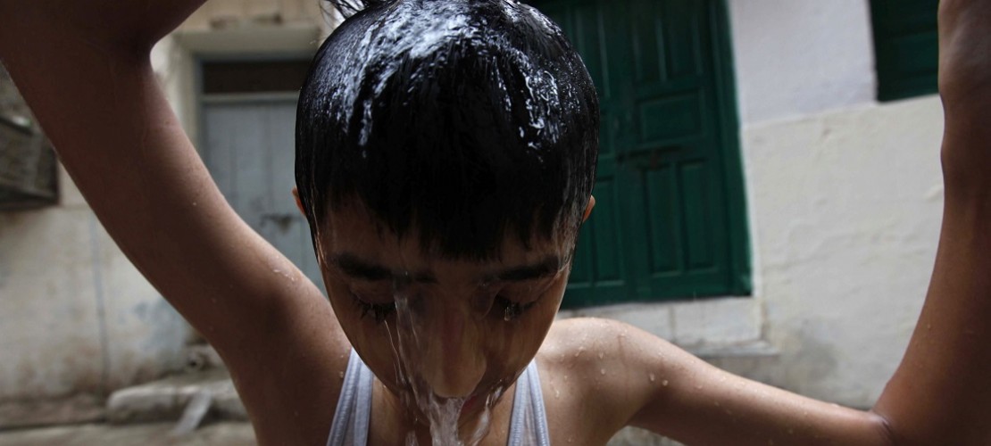 Wer kann, verschafft sich in Pakistan Abkühlung. Zum Beispiel, indem er sich Wasser über den Kopf schüttet. (Foto: dpa)